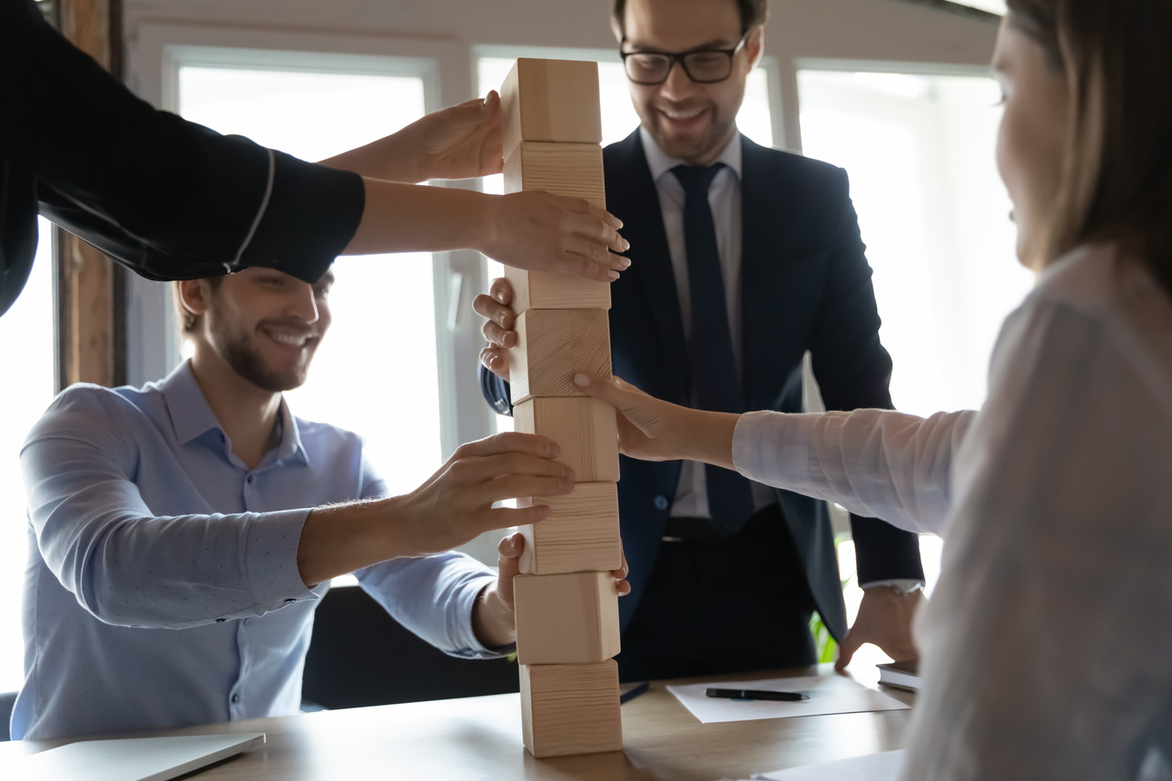 Close up happy diverse employees involved in team building activity